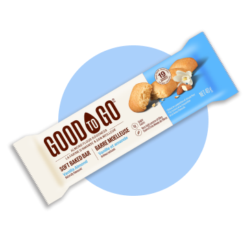 An individually wrapped GOOD TO GO Vanilla Almond Soft Baked Bar on a circular blue background.